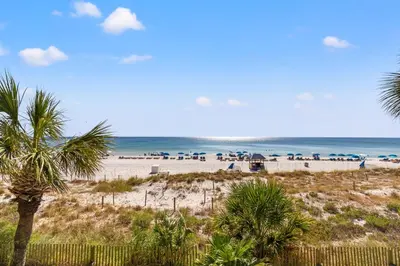 a beach with a lot of umbrellas and the ocean at Commodore 0201 in Panama City Beach