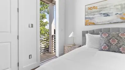 a white bedroom with a bed and a window at Family-Friendly 30A Stay Pool Access Firepit Steps to the Beach Driftwood Dreams by AvantStay in Inlet Beach