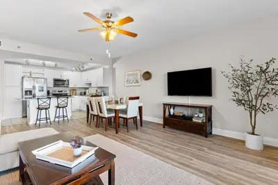 a living room with a ceiling fan and a table at Family-Friendly Laketown Wharf Retreat w/ Pools & Walk to Beach in Panama City Beach