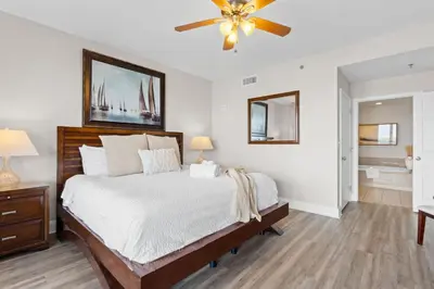 a bedroom with a bed and a ceiling fan at Family-Friendly Laketown Wharf Retreat w/ Pools & Walk to Beach in Panama City Beach