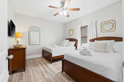 a bedroom with two beds and a ceiling fan at Family-Friendly Laketown Wharf Retreat w/ Pools & Walk to Beach in Panama City Beach