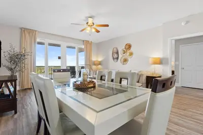 a dining room and living room with a table and chairs at Family-Friendly Laketown Wharf Retreat w/ Pools & Walk to Beach in Panama City Beach
