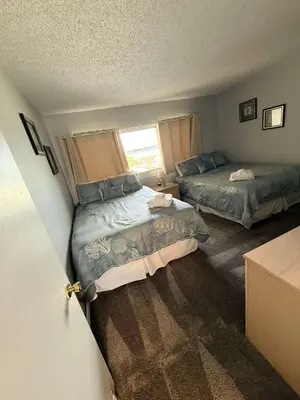 a bedroom with two beds and a window at Sand, Sea & Air at Pinnacle Port A-301 in Panama City Beach