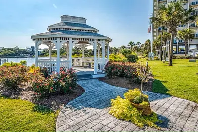 a gazebo in a park next to a building at Sand, Sea & Air at Pinnacle Port A-301 in Panama City Beach