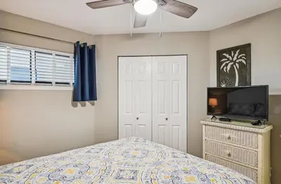a bedroom with a bed and a ceiling fan at Aquavista 603W by Emerald Coast Retreats in Panama City Beach