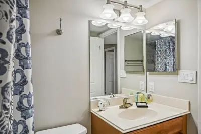 a bathroom with a sink and a mirror at Aquavista 603W by Emerald Coast Retreats in Panama City Beach