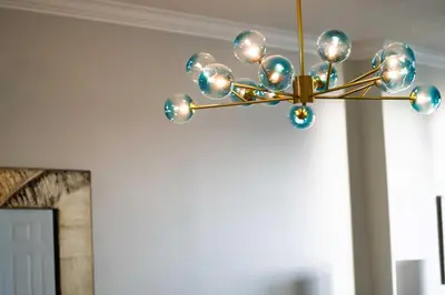 a chandelier hanging from a ceiling in a room at Luxury 2BR Beachfront Condo - Panama City Beach in Panama City Beach