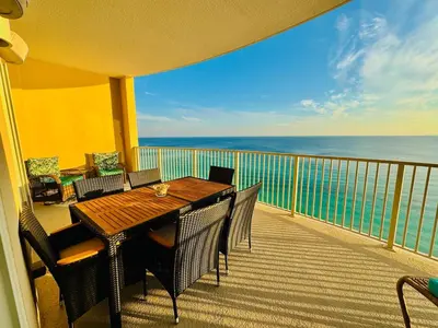 a balcony with a table and chairs and the ocean at Luxury 2BR Beachfront Condo - Panama City Beach in Panama City Beach