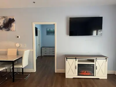 a living room with a tv and a fireplace at Beautiful Resort Condo Panama City Beach King Bed in Panama City Beach