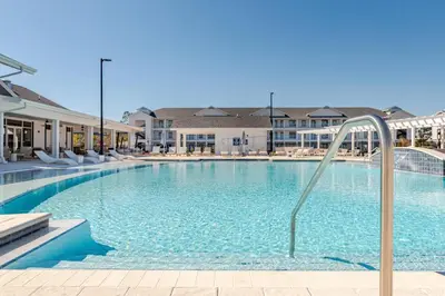 a large swimming pool with blue water and buildings at King Condo Panama City Beach All Amenities Resort in Panama City Beach