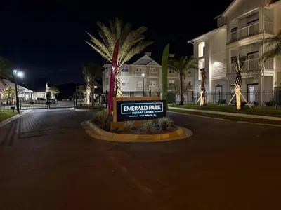 a sign in the middle of a street at night at King Condo Panama City Beach All Amenities Resort in Panama City Beach