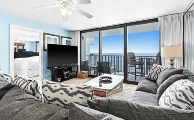 a living room with a couch and a television at Book Me Baby! The One at One Seagrove Place in Seagrove Beach