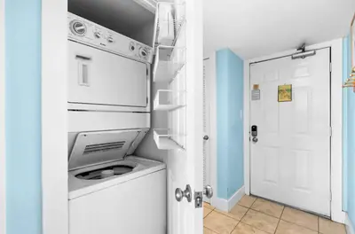 a kitchen with a washer and dryer in a room at Book Me Baby! The One at One Seagrove Place in Seagrove Beach