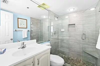 a bathroom with a shower and a sink and a toilet at Book Me Baby! The One at One Seagrove Place in Seagrove Beach