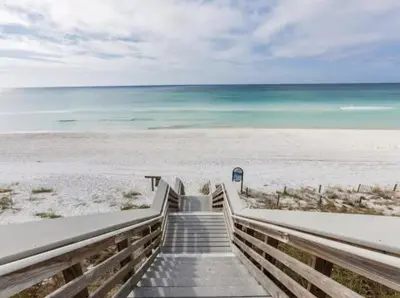 a staircase leading to a beach with the ocean at Book Me Baby Big Chill in Prominence Golf Cart Included in Inlet Beach