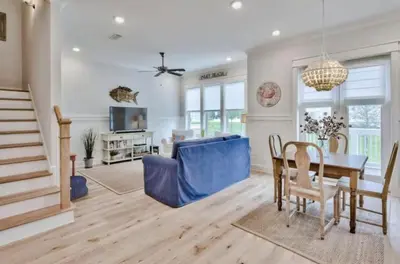 a living room with a table and a blue couch at Book Me Baby Big Chill in Prominence Golf Cart Included in Inlet Beach