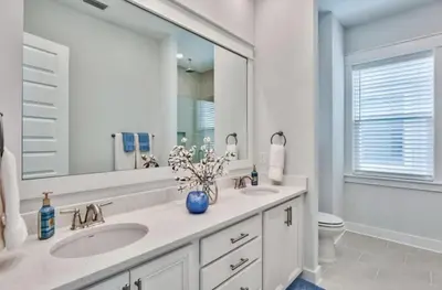 a bathroom with two sinks and a large mirror at Book Me Baby Big Chill in Prominence Golf Cart Included in Inlet Beach