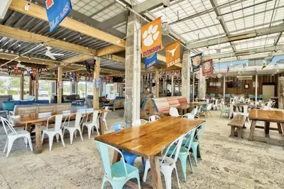 a group of tables and chairs in a restaurant at Book Me Baby Big Chill in Prominence Golf Cart Included in Inlet Beach