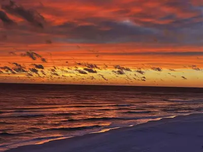 a sunset on the beach with the ocean at Book Me Baby Big Chill in Prominence Golf Cart Included in Inlet Beach