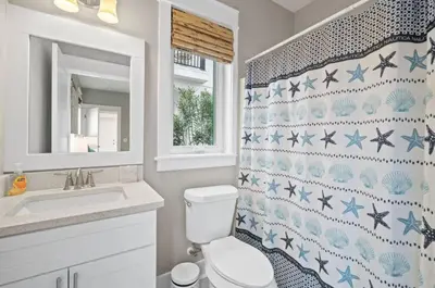 a bathroom with a toilet and a sink at Know When To Hold Em in Inlet Beach in Inlet Beach