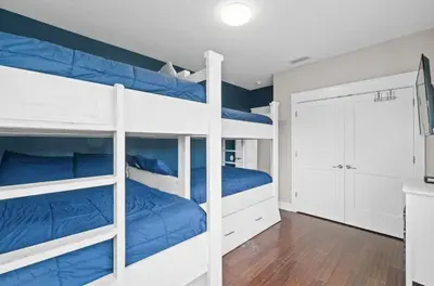a bedroom with two bunk beds with blue sheets at Know When To Hold Em in Inlet Beach in Inlet Beach