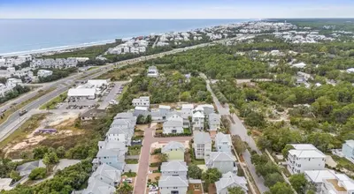 an aerial view of a neighborhood with houses and the ocean at Know When To Hold Em in Inlet Beach in Inlet Beach