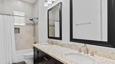 a bathroom with two sinks and a shower at Serene 30A Getaway Steps from the Gulf with BBQ Wraparound Porch 30A Fade Away by AvantStay in Santa Rosa Beach