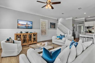 a living room with white furniture and blue pillows at Geauxing Coastal 10 ppl 3 BR 3BA Bikes Community pool 5 Min walk to the beach in Seacrest