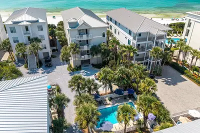 an aerial view of a resort with a pool and palm trees at 4 BR GULF Front Condo, Bikes, & Community Pool in Seagrove Beach