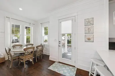 a white dining room with a table and chairs at NEW! Fall Break OPEN 4 BR, Pool, Bikes & close to shopping & beach in Seagrove Beach
