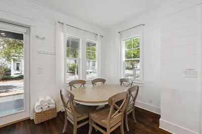 a dining room with a table and chairs at NEW! Fall Break OPEN 4 BR, Pool, Bikes & close to shopping & beach in Seagrove Beach
