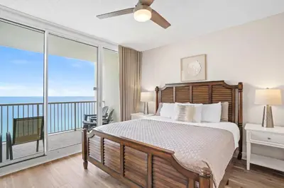 a bedroom with a large bed and a balcony at Majestic Beach Towers 1-1903 by Emerald Coast Rereats in Panama City Beach
