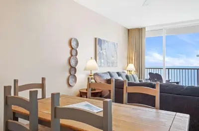 a living room with a couch and a table at Majestic Beach Towers 1-1903 by Emerald Coast Rereats in Panama City Beach