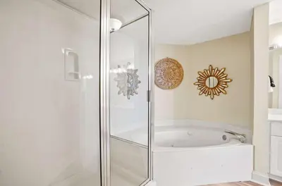 a glass shower in a bathroom with a tub at Majestic Beach Towers 1-1903 by Emerald Coast Rereats in Panama City Beach