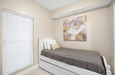 a bedroom with a bed and a painting on the wall at Majestic Beach Towers 1-1903 by Emerald Coast Rereats in Panama City Beach