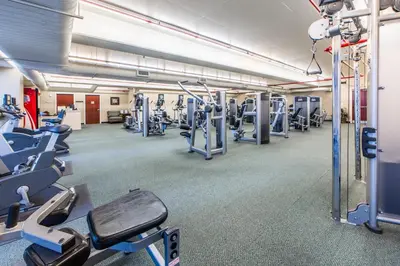 a gym with lots of treadmills and machines at Majestic Beach Towers 1-1903 by Emerald Coast Rereats in Panama City Beach