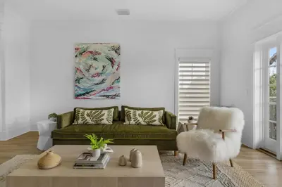 a living room with a green couch and a coffee table at 30a Seagrove Beach Condo with Gulf & Lake Views in Santa Rosa Beach