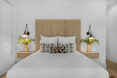 a bedroom with a large white bed with pillows at 30a Seagrove Beach Condo with Gulf & Lake Views in Santa Rosa Beach