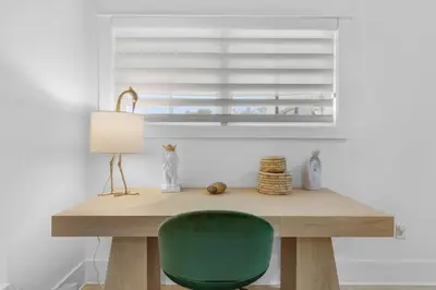 a desk with a green chair and a window at 30a Seagrove Beach Condo with Gulf & Lake Views in Santa Rosa Beach
