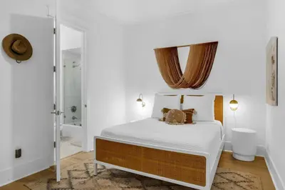 a bedroom with a bed and a mirror on the wall at 30a Seagrove Beach Condo with Gulf & Lake Views in Santa Rosa Beach