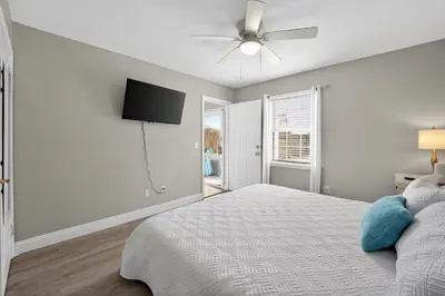 a bedroom with a bed and a ceiling fan at Luxury Beach Access in Panama City Beach