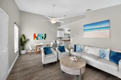 a living room with a couch and chairs and a table at Luxury Beach Access in Panama City Beach