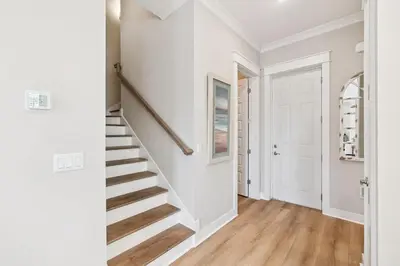 a staircase in a home with white walls and wood floors at 30A All Day 88 E Pine Lands Loop Unit A in Inlet Beach