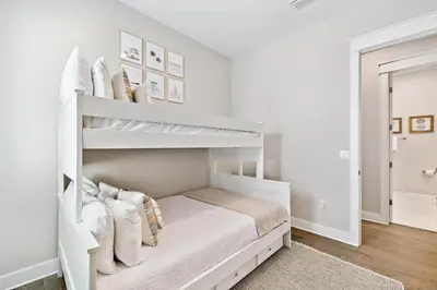 a white bedroom with a white bunk bed at 30A All Day 88 E Pine Lands Loop Unit A in Inlet Beach