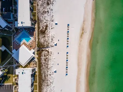 an overhead view of a beach with parked cars at Turtle Cove at Sugar Beach #E16 by Nautical Properties Vacation Rentals in Panama City Beach