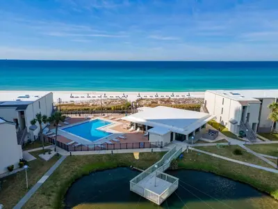 an aerial view of a resort with a swimming pool and the beach at Turtle Cove at Sugar Beach #E16 by Nautical Properties Vacation Rentals in Panama City Beach