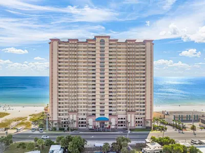 a large building next to the beach and the ocean at Music City Flamingo at Sunrise Beach Resort #705 by Nautical Properties in Panama City Beach
