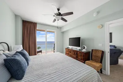 a bedroom with a bed and a flat screen tv at Music City Flamingo at Sunrise Beach Resort #705 by Nautical Properties in Panama City Beach