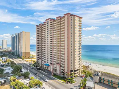 an aerial view of a tall building next to the beach at Music City Flamingo at Sunrise Beach Resort #705 by Nautical Properties in Panama City Beach