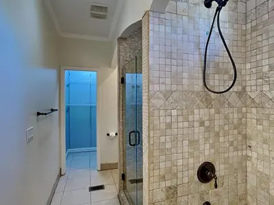 a bathroom with a shower with a glass door at Lazy River Retreat in Panama City Beach